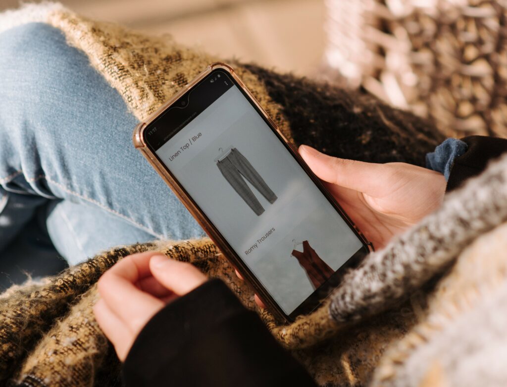 A mobile device with a user shopping for women’s apparel on an e-commerce store’s website showing the need for SEO